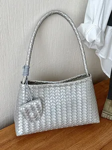 Elegant silver woven underarm shoulder bag for women with matching heart-shaped charm