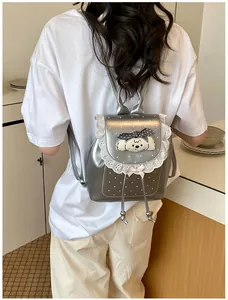 Detailed back view of a silver metallic mini backpack with sweet lace trim and puppy detail
