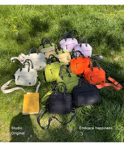 Colorful multi-functional mini backpacks and crossbody bags on grass for outdoor travel