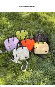 Six colorful multi-functional mini crossbody bags displayed on a green grass field