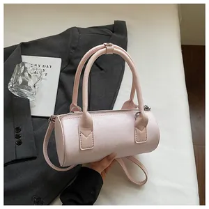 Detailed view of stylish pink cylindrical handbag with star pattern and double handles