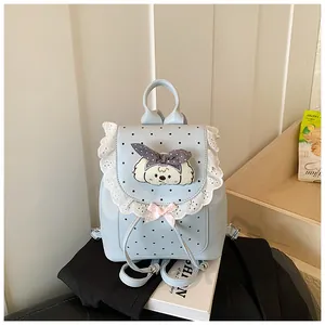 Exquisite detail of a light blue mini backpack with lace trim and a cute dog patch