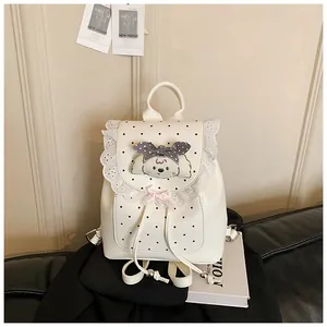 Close-up of a white mini backpack featuring lace trim, polka dots, and a cute bow.