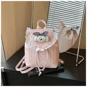 Detail view of pink sweet-style mini backpack with delicate lace trim and cute dog decor