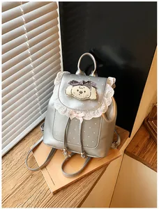 Sweet silver mini backpack featuring delicate lace trim and cute puppy patch details