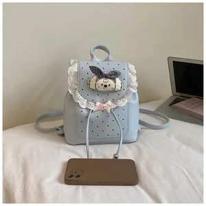 Sweet light blue mini backpack with lace trim and cute puppy patch shown with phone for scale