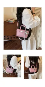 Asian model wearing a stylish pink textured crossbody bag with a pony charm in a room
