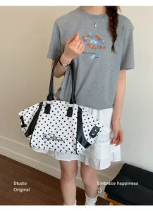 Large capacity polka dot nylon tote bag for women in a stylish lifestyle setting