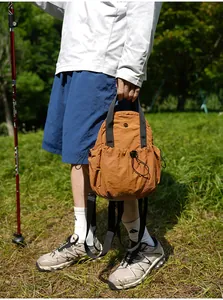 Close-up of lightweight brown nylon backpack in outdoor trekking setting