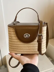 Sac seau en paille tressée avec rabat en cuir marron et poignée pour la plage