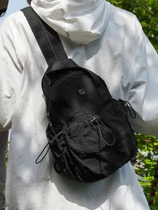 Lightweight black nylon sling bag for women with drawstring pocket and adjustable strap