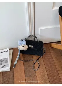 Classic black quilted mini square bag featuring a cute plush bear charm and chain strap