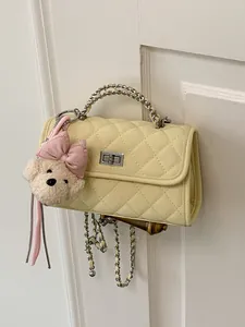 Elegant light yellow quilted crossbody square bag with silver chain and plush bear charm