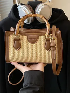 Woven straw handbag with bamboo top handle and leather trim for summer beach style