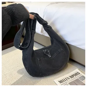Detailed view of a black denim hobo bag with large capacity for daily commute.
