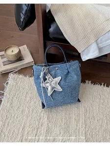 Vintage denim handbag with star pendant and bear charm for women's daily commute.