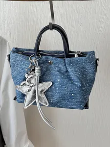 Casual blue denim dumpling handbag for women with silver star and balloon dog charm