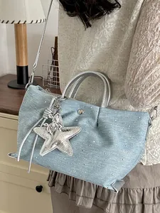Light blue denim handbag with silver star charm and sparkly studs for casual wear