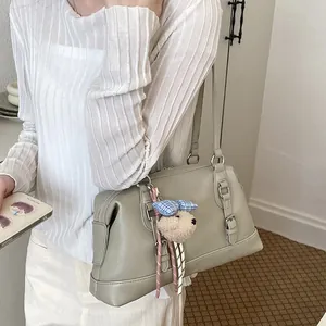 Elegant light grey pillow bag for women, chic commuter shoulder bag with bear charm