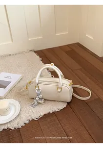 Exquisite white minimalist pillow bag displayed in a cozy retro lifestyle setting.