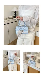 Sweet blue polka dot Boston handbag featuring lace bow and cute dog plush keychain