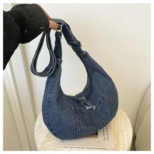 Large capacity blue denim hobo bag with front pocket for daily commute.