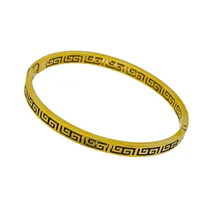 Detailed view of 18k gold-plated bangle featuring a classic Greek key meander pattern.
