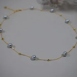Detailed view of grey pearl star necklace on a fine gold-plated titanium steel chain