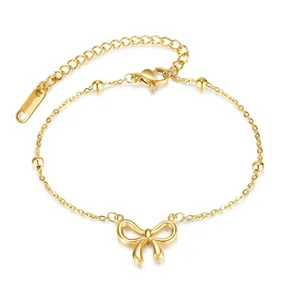 Close-up of gold-plated titanium steel bracelet with bow pendant and beads