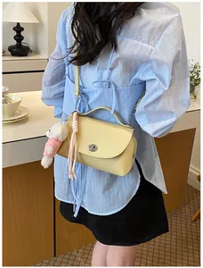 Fashionable vintage yellow pebbled leather crossbody bag with cute white bear charm detail