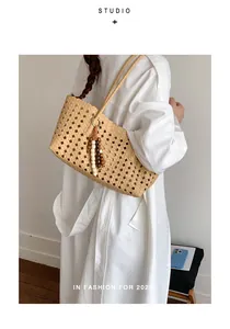 Beige minimalist woven hollow-out tote bag with beaded tassel detail for daily use