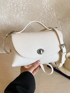 Elegant white pebbled leather crossbody bag with vintage silver turn-lock closure