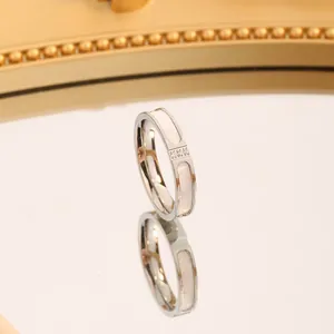 Macro view of a modern titanium steel ring with white shell inlay and three sparkling stones.