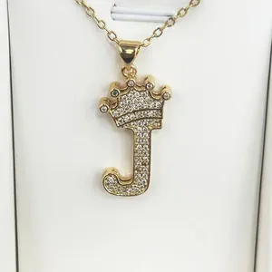 Elegant gold-tone initial J pendant necklace with crown motif and sparkling cubic zirconia