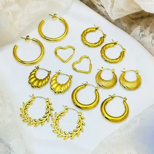 Detailed view of multiple gold-plated stainless steel hoop and heart earring designs.