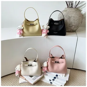 Collection of elegant lychee grain bucket bags with teddy bear charms in four colors.