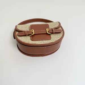 Close-up of brown leather and straw woven saddle bag for beach vacation