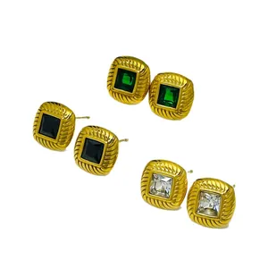 Close-up of French vintage threaded earrings with green, black and clear stones