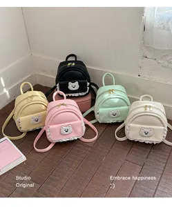 Collection of colorful mini backpacks featuring cute bear patches and delicate lace details