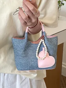 Trendy denim contrast color bucket bag for women featuring a cute heart pearl charm