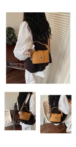 Lifestyle view of mustard yellow women's bucket bag with a cute bear keychain
