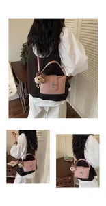 Detailed view of pink crossbody bucket bag with cute bear charm and silver hardware