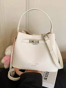 Women's chic white leather bucket handbag with top handle and bear charm