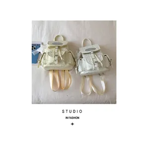 Detail view of two sweet star pattern canvas backpacks in cream and white colors