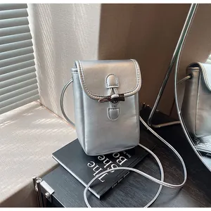 Minimalist silver cell phone crossbody bag with stylish horn buckle and thin strap