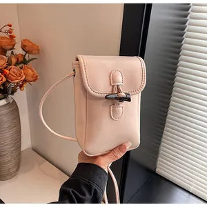 Elegant pink crossbody phone bag for women featuring a stylish wooden toggle closure