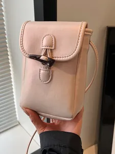 Elegant pink small crossbody phone bag with a stylish horn toggle and slim strap