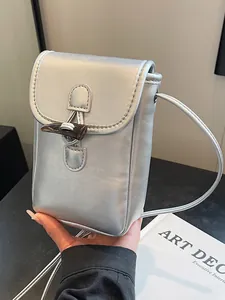 Minimalist silver metallic crossbody phone bag with a stylish horn toggle closure for women