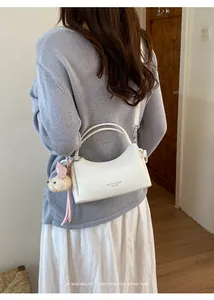 Trendy white leather crossbody bag for women in a minimalist fashion lifestyle setting