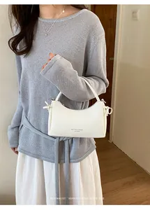 Elegant white minimalist small handbag for women featured in a chic retro vibe